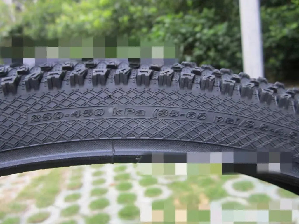 Ultralight black mountain bike tyre with puncture proof tread, shown in 26, 27.5 and 29 inch sizes.