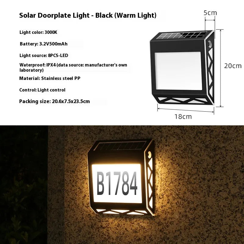Black solar-powered outdoor doorplate light with digital LED number display mounted on a wall