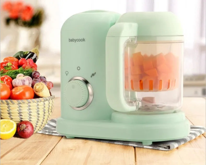 Green baby food processor with steamer and blender functions showing control panel and processing bowl