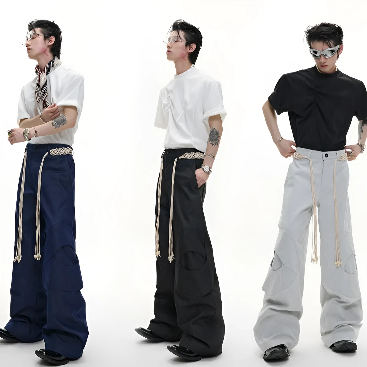 Men's dark blue loose straight-leg jeans with 3D cutting, heavy belt stitching, and pocket tassel details.