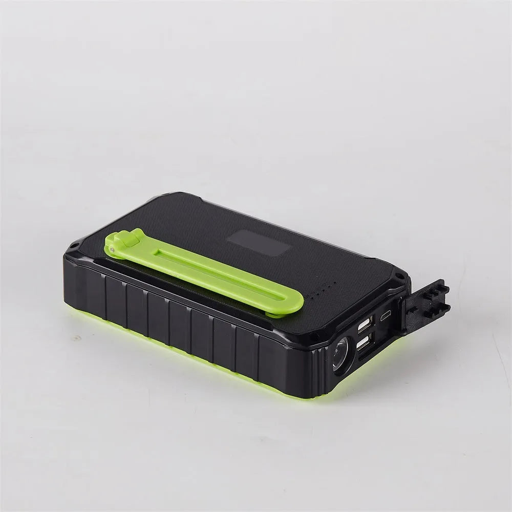 Orange or green hand crank solar power bank with solar panel, dual USB ports, and LED light.
