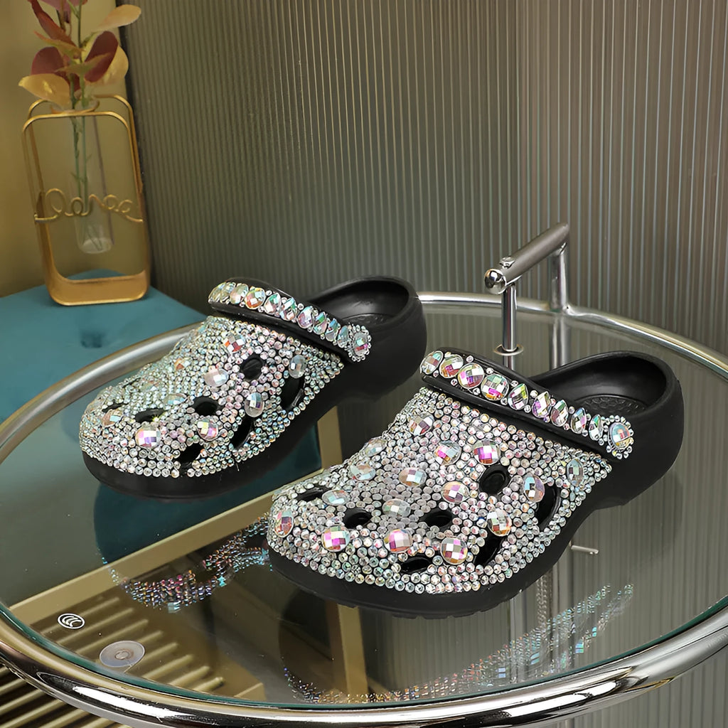 Black women's platform sandals with rhinestone details on an EVA upper and sole.