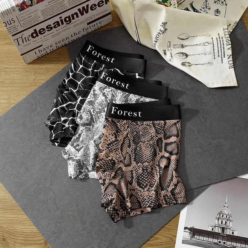 Men's loose fit boxer shorts in thin black polyester fabric laid flat