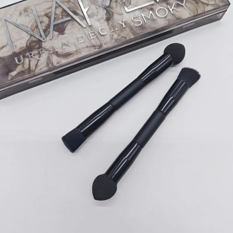 Elegant black double-headed makeup brush with miter sponge and angled concealer heads on a wooden handle.