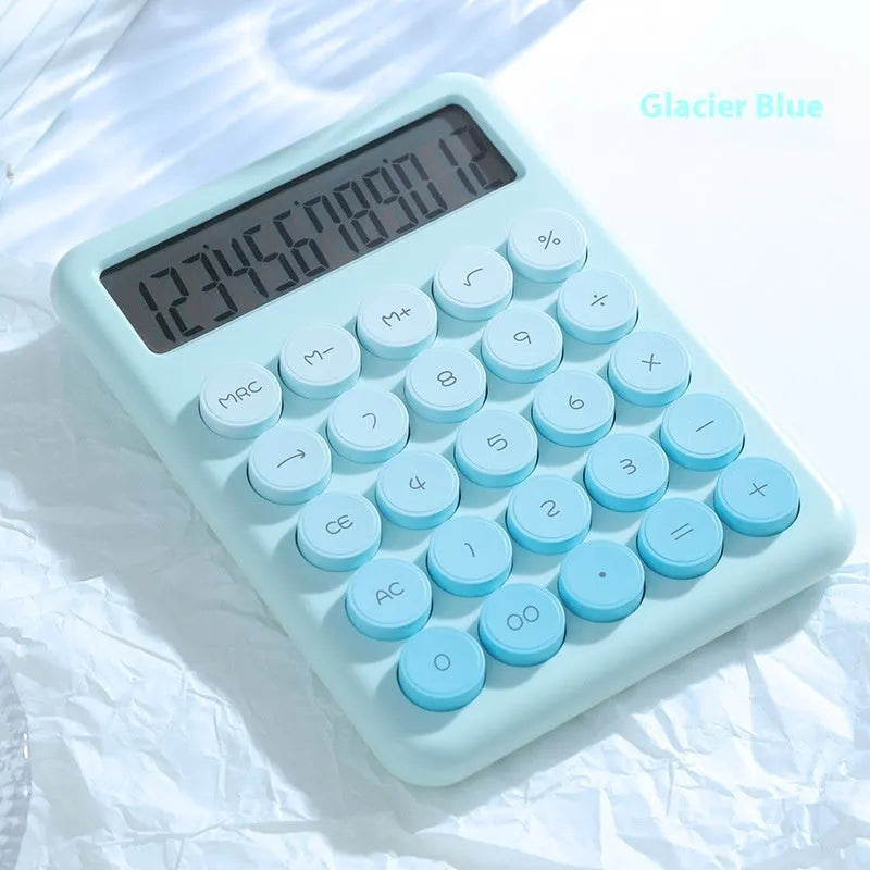 A gradient colour desktop calculator in violet, pink, blue, or green on a desk.