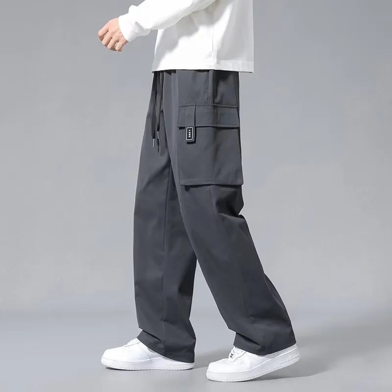 Boys' straight leg cargo pants in army green with drawstring waist and large cargo pockets.