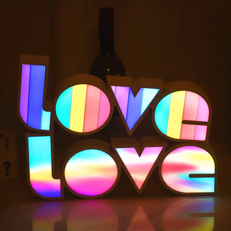 LED LOVE Light with colourful rainbow lampshade on a desk