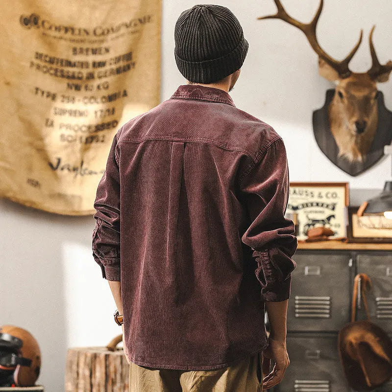 Men's loose fit corduroy shirt jacket in red or black, showing long sleeves and textured fabric.