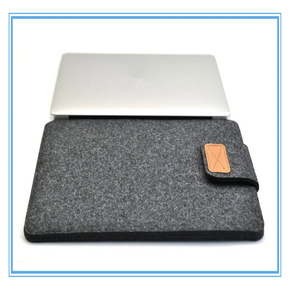 Dark grey clamshell laptop bag made of woven plush material, shown open to reveal the internal computer compartment.