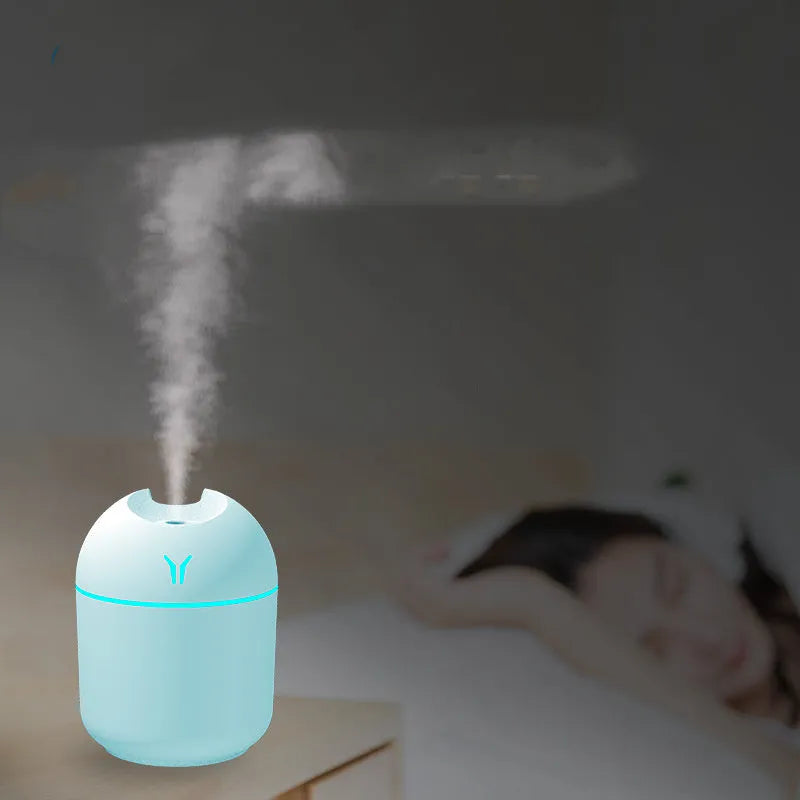 Round desktop humidifier in ivory white with USB cable and single mist outlet