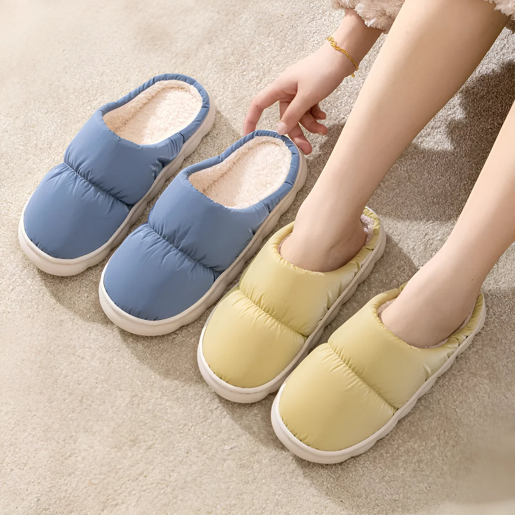 Blue down cotton slippers with a thick rubber sole and plush lining for indoor winter wear.