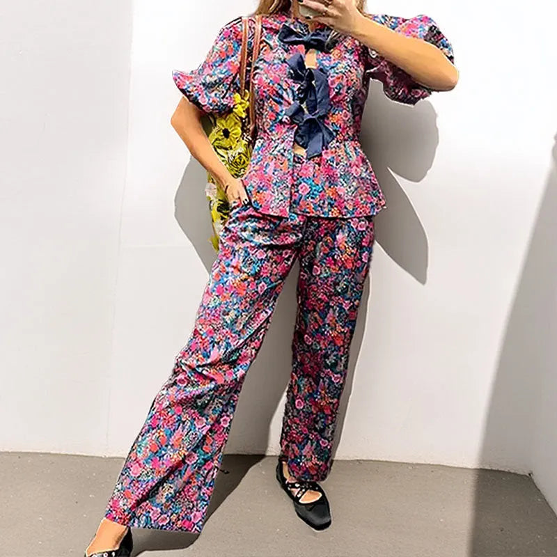 Women's floral print polyester trouser suit with puff sleeves and tie-neck blouse