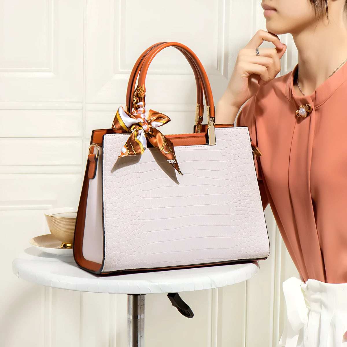 Milky white women's large shoulder handbag with internal compartments and slit pocket.