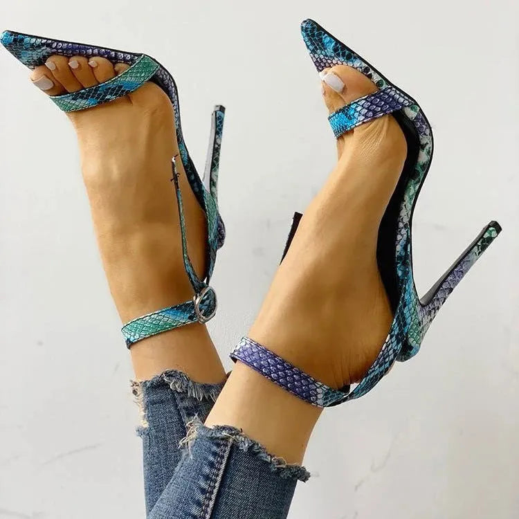 Blue serpentine style high heels with buckle fastening and hollow-out detailing on pointed toe