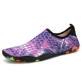 Pair of blue Lycra beach wading shoes with EVA midsole on a sandy beach background.