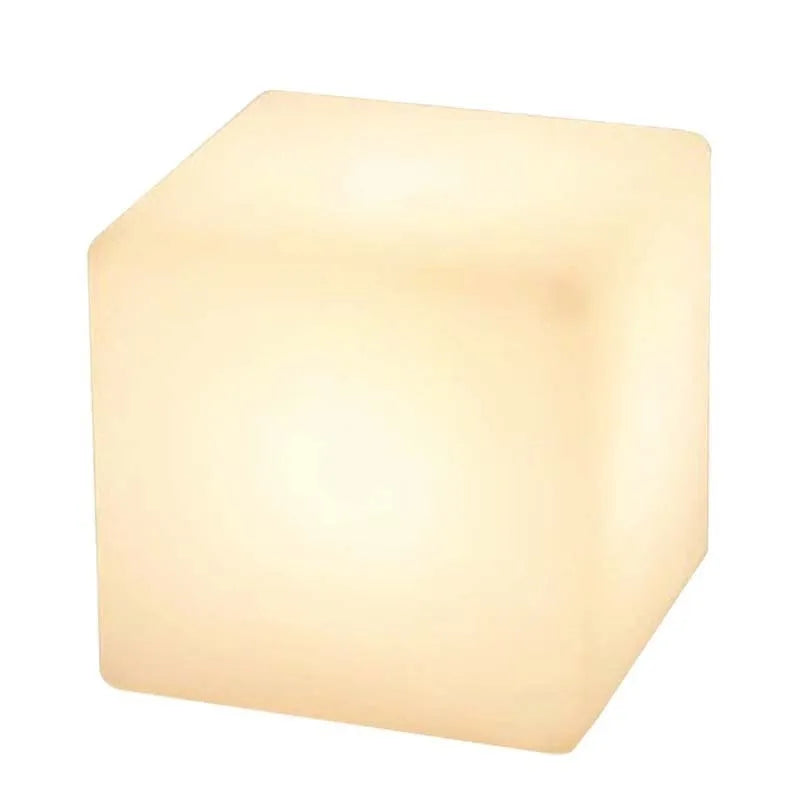 Modern white LED cube stool light outdoors, showing clean square design and soft illumination.