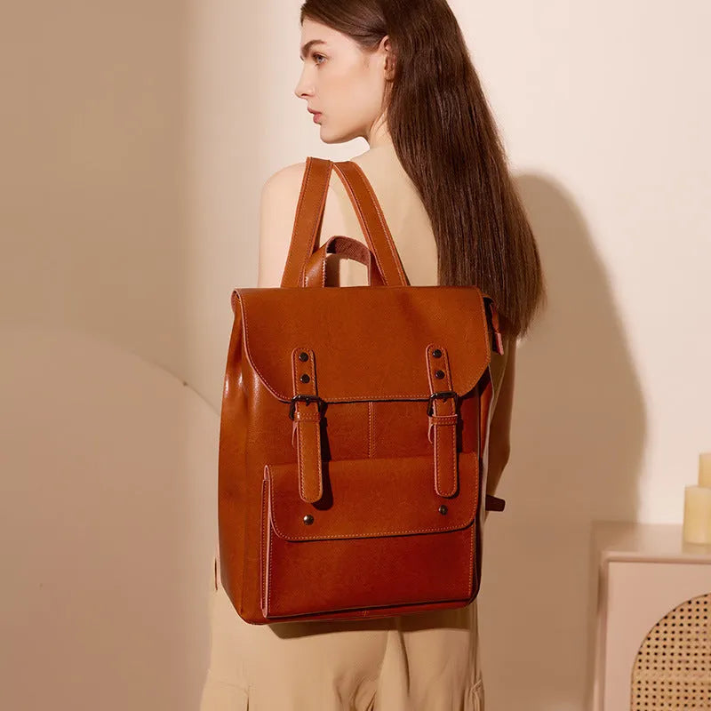 Women's cowhide leather computer backpack in black, brown, or coffee with hard structure and wear-resistant finish