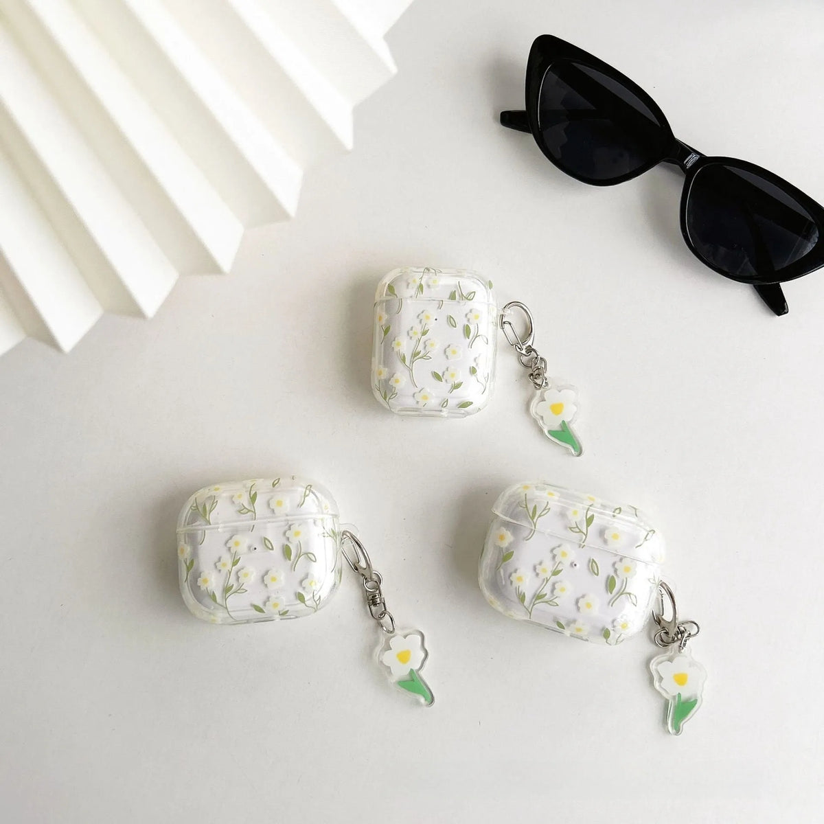White floral decorative pattern on a high transparency TPU protective case for Apple AirPods.