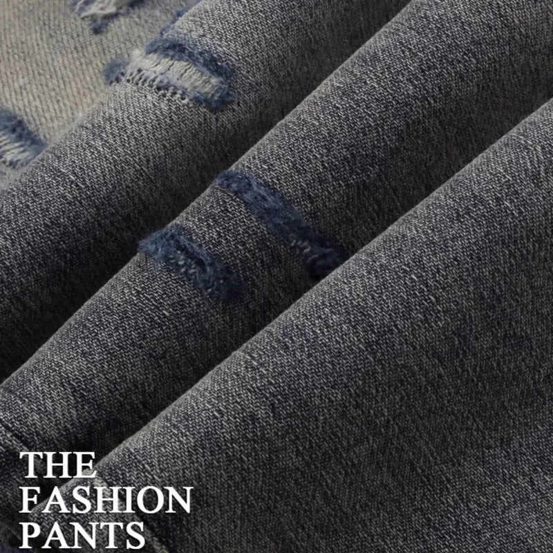 Old colour slim fit jeans with hole patches and embroidered detailing on worn cotton fabric