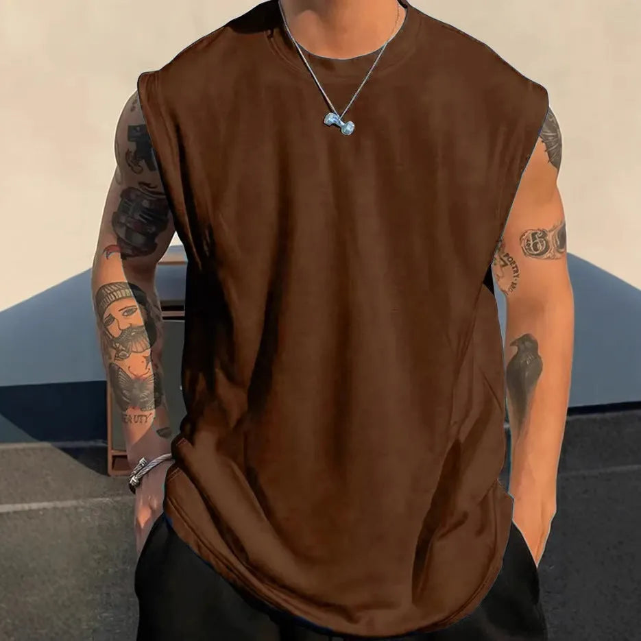 Men's loose fit solid colour cotton tank top on a hanger, shown in apricot colour.