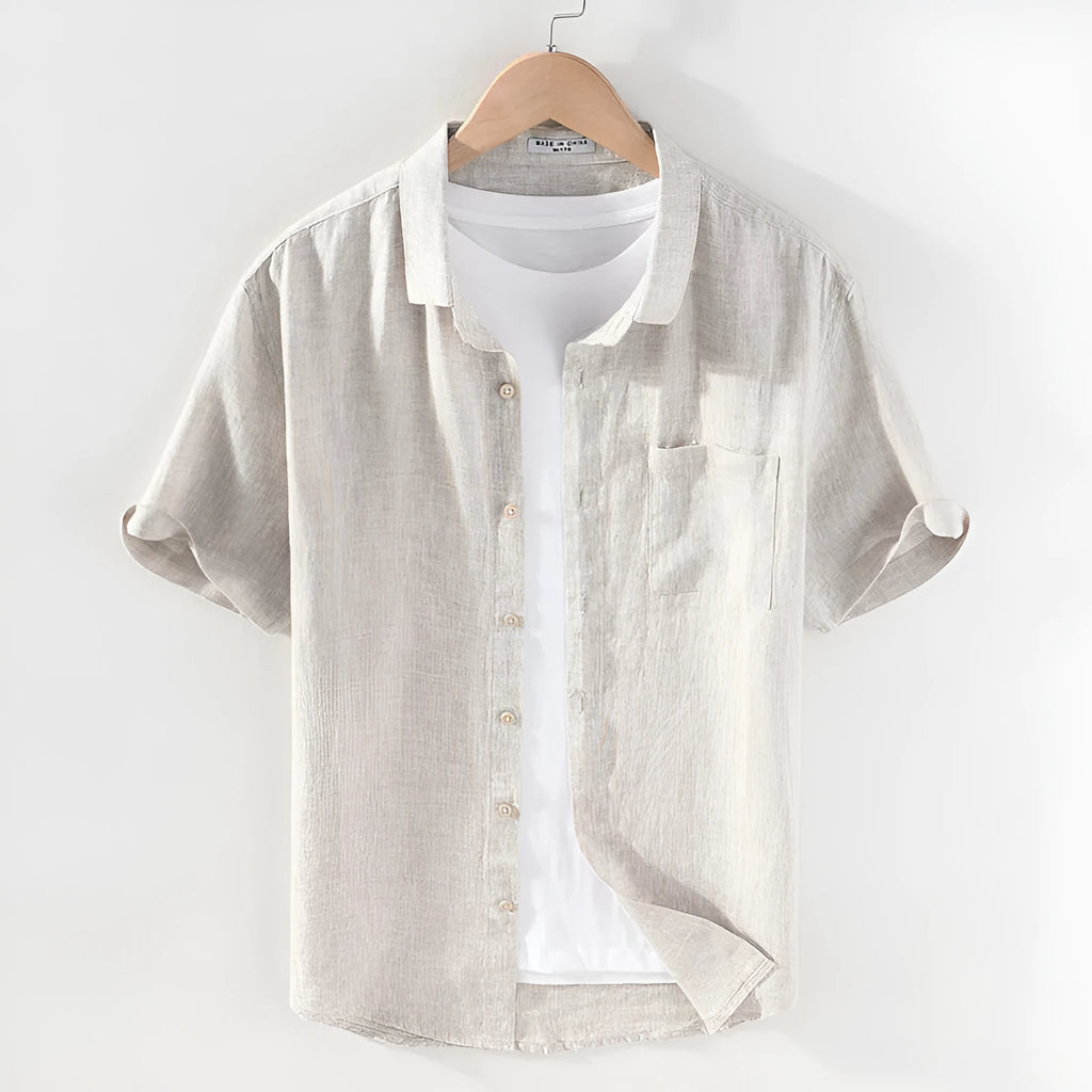 Male model wearing a short sleeve linen shirt with a square collar in raw jute colour.