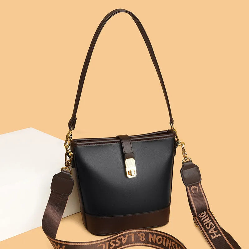 Korean style black bucket messenger bag with double shoulder strap showing zip compartments and urban design details