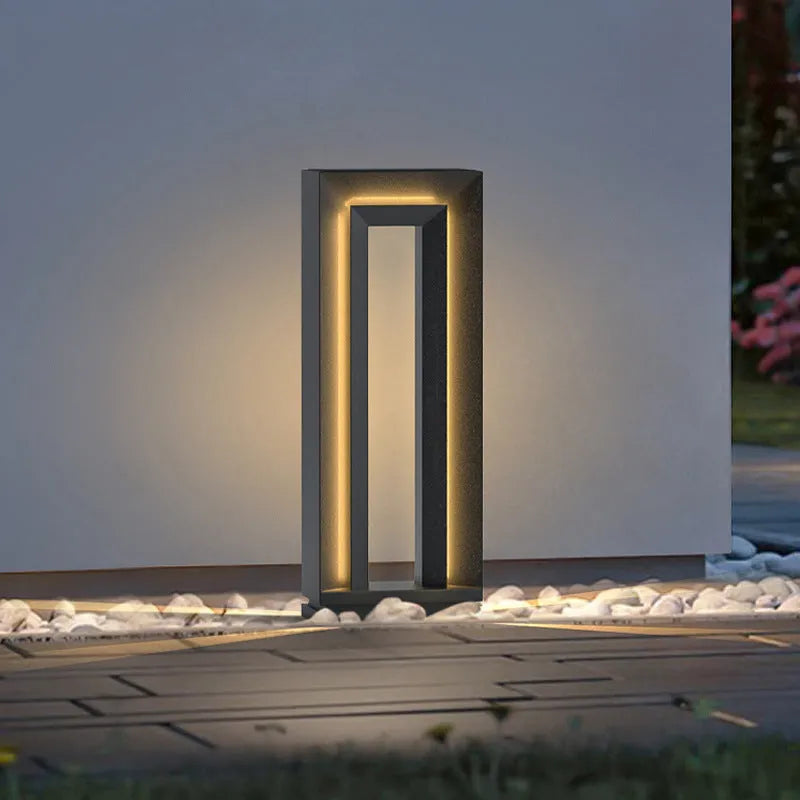 A modern square-shaped stainless steel and acrylic outdoor garden lamp with a geometric design.