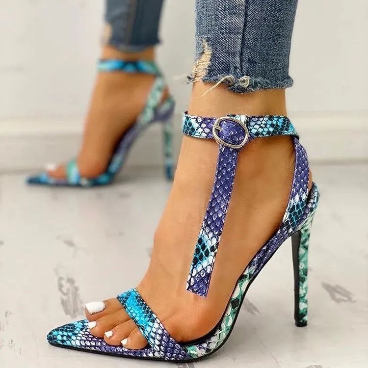 Blue serpentine style high heels with buckle fastening and hollow-out detailing on pointed toe