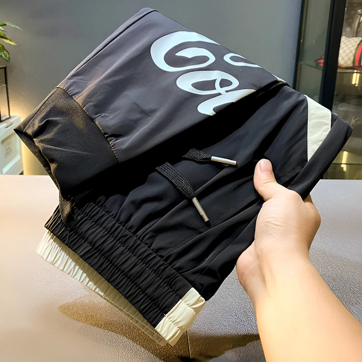 Black men's cropped casual trousers with ankle band, made from ultra-thin ice silk fabric.