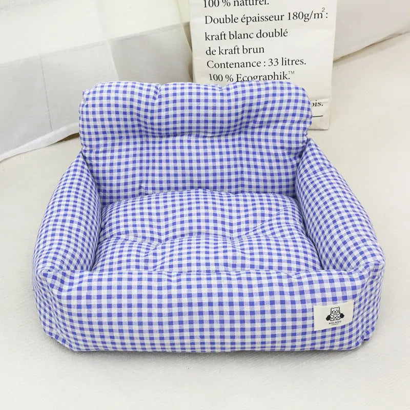 Grey and blue plaid stain-resistant dog carrier for car travel with foldable sides.