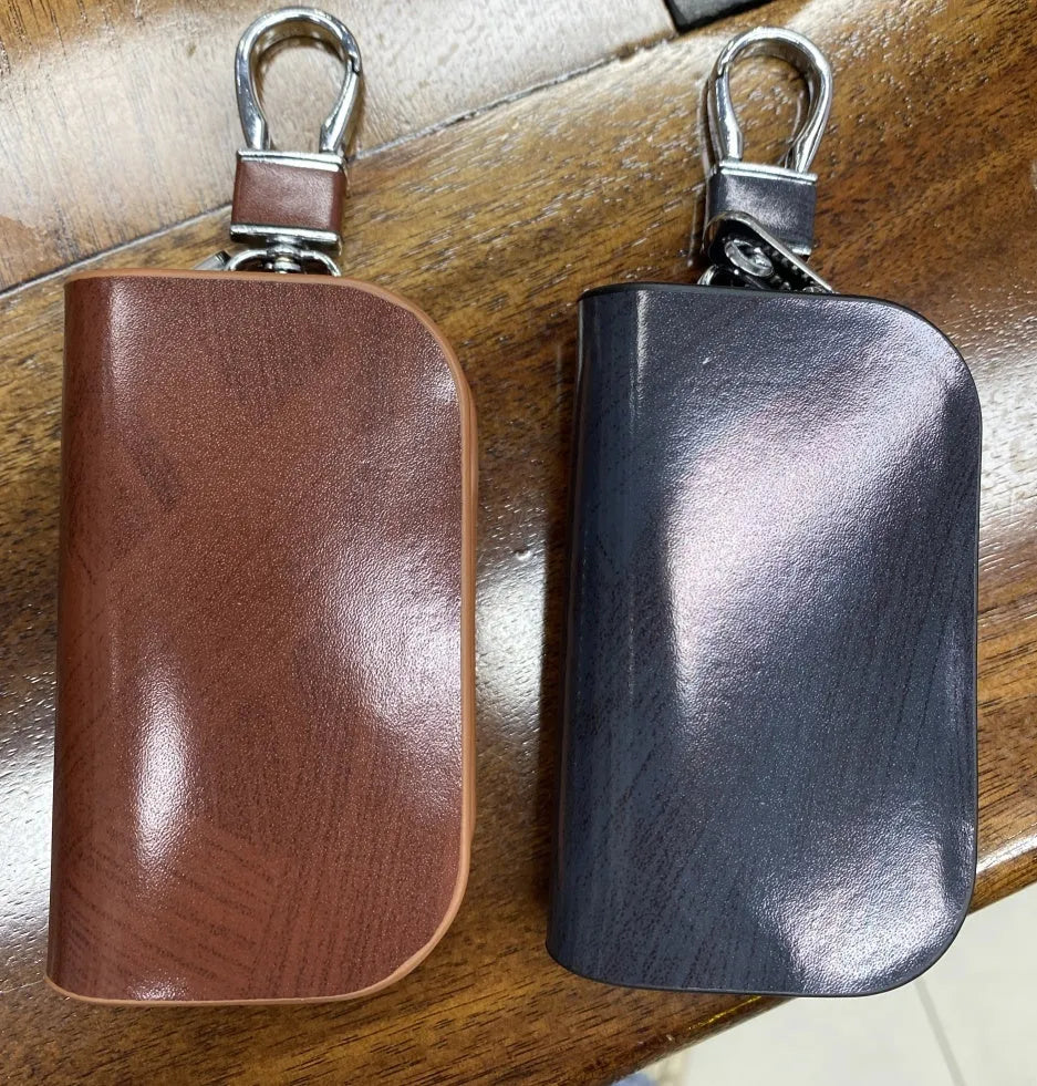 V-shaped genuine leather car key case with frosted finish showing black and brown colour options