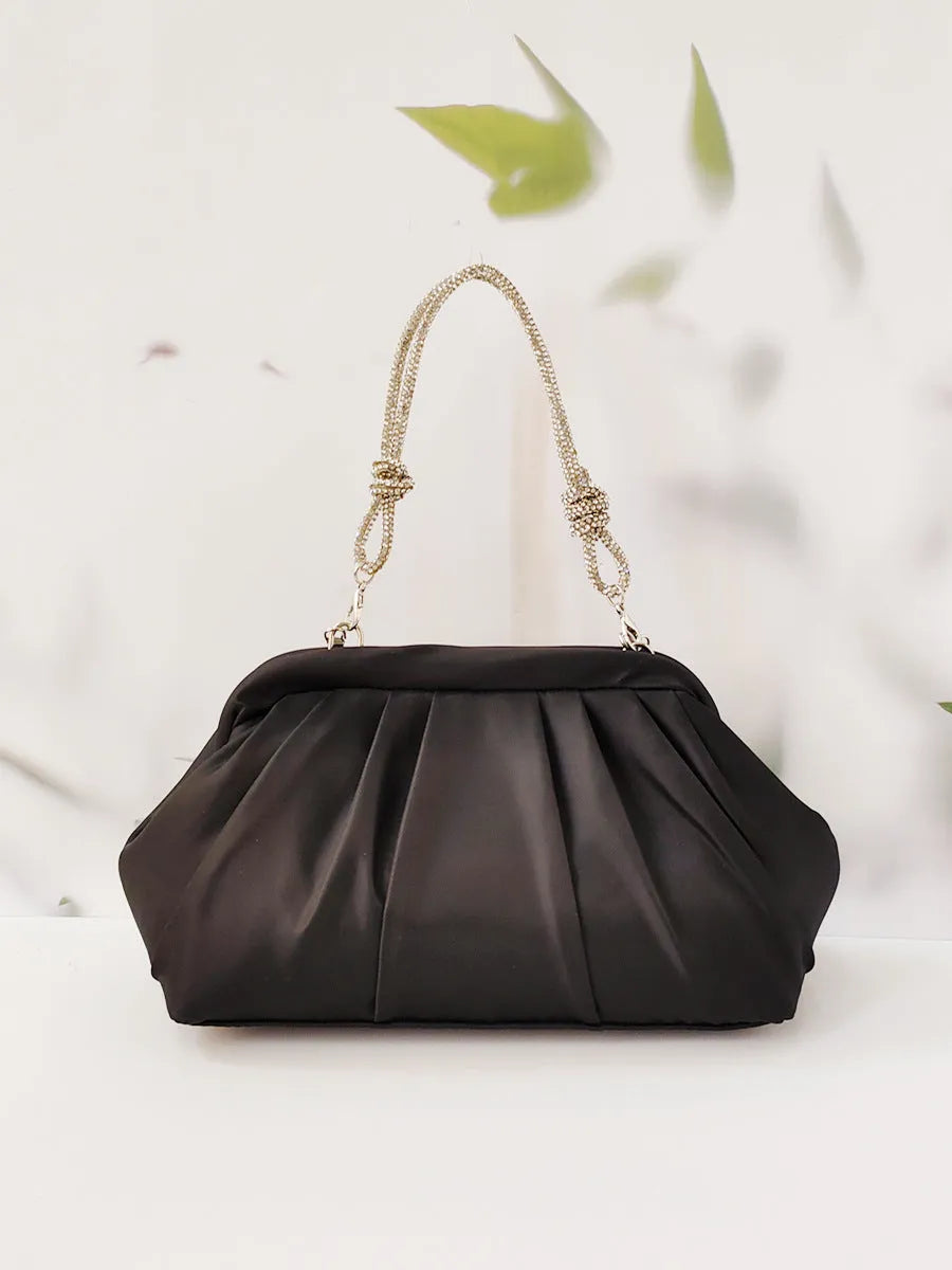 Women's soft polyester messenger bag with diamond quilting and chain strap in black colour