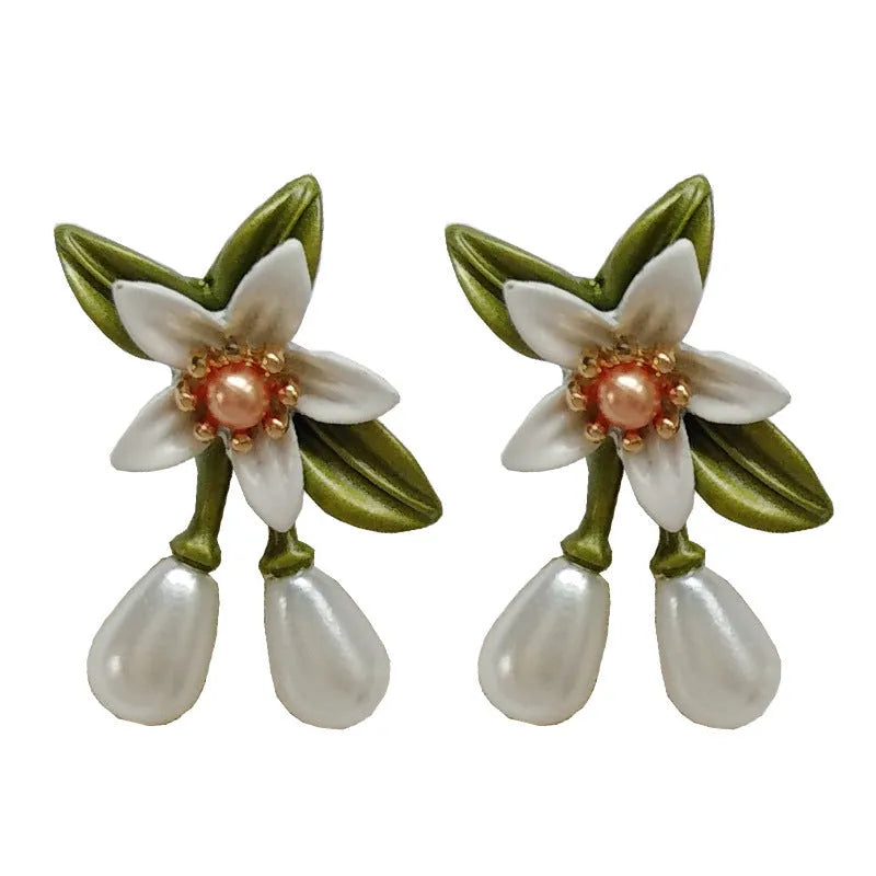 Alloy flower earrings for women, showing stud and clip styles with contrasting colour floral design.