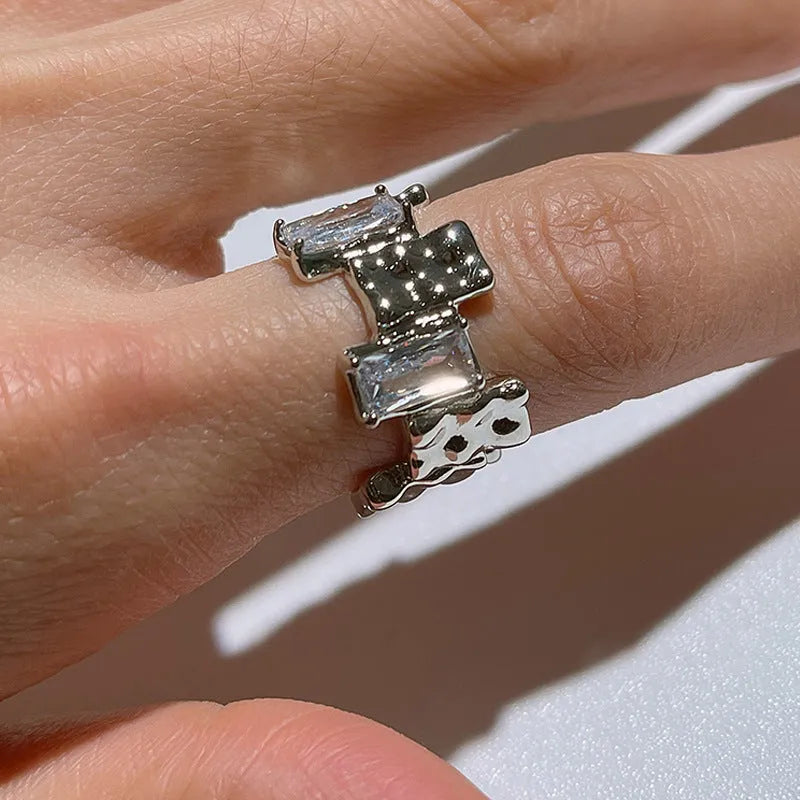 Silver geometric cross ring with open zircon setting and retro design
