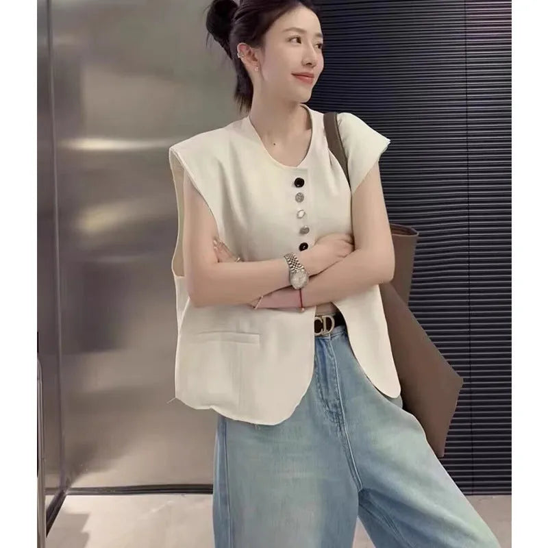 Women's loose-fit short vest in milky white with a chest pocket, shown on a hanger.