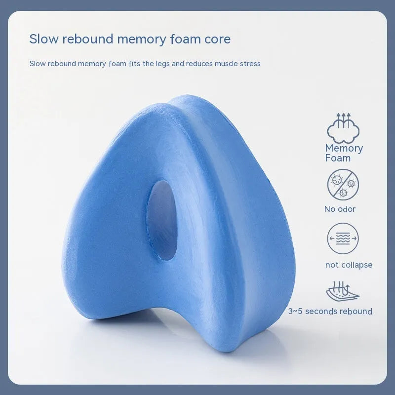 Dark blue jacquard love heart-shaped memory foam leg pillow on a grey sofa