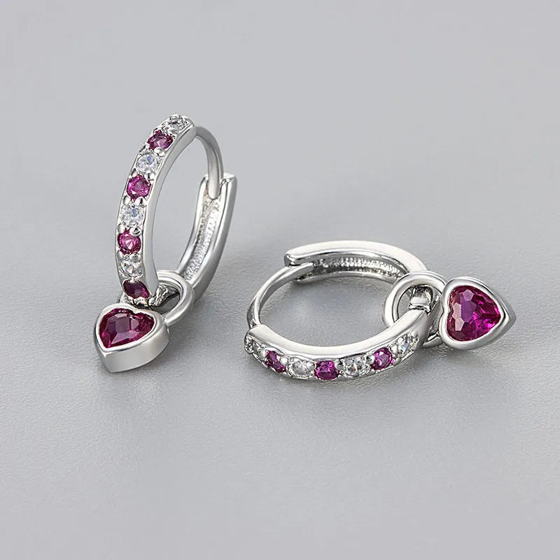 Women's fashion earrings with heart-shaped drops featuring coloured zircon stones in gold or white gold colour plating