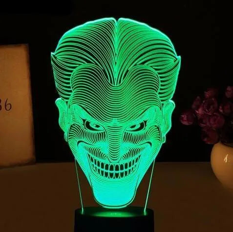 USB-powered 3D acrylic LED table lamp with remote control on a desk, displaying a gradient colour mode.