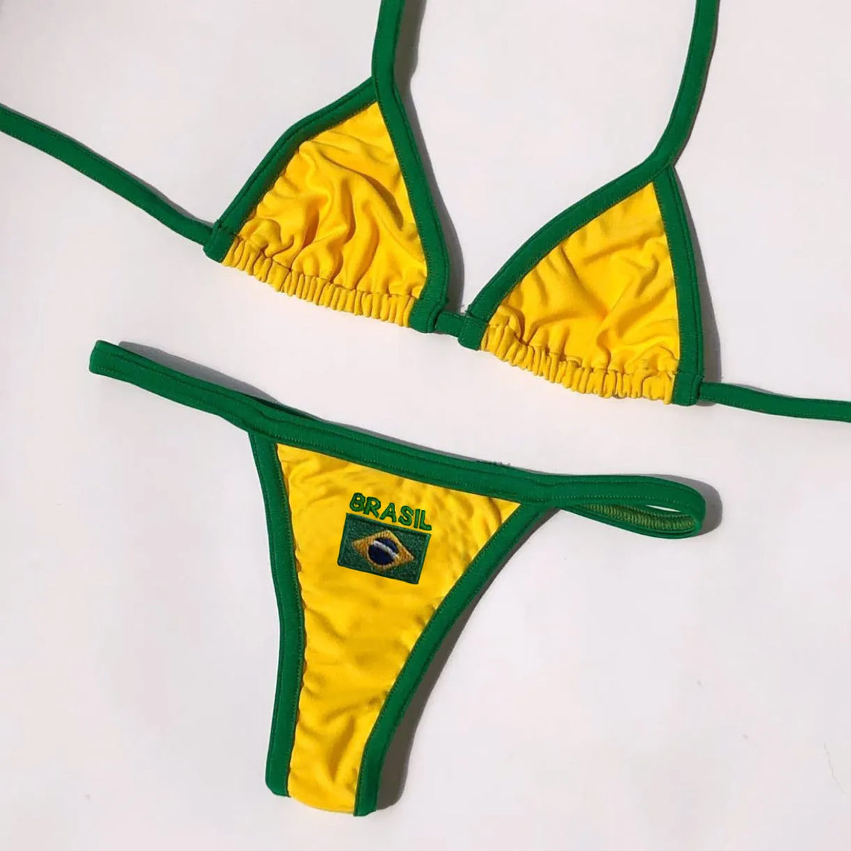 Women's yellow polyester T-back bikini set with matching shorts on a mannequin.