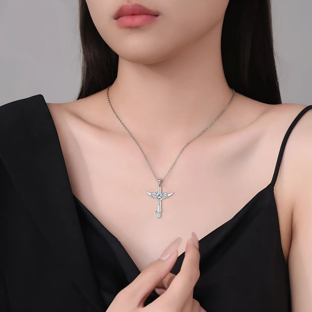 Close-up of a copper stethoscope cross pendant with wing details on a chain, available in Red Diamond or White Diamond finish.