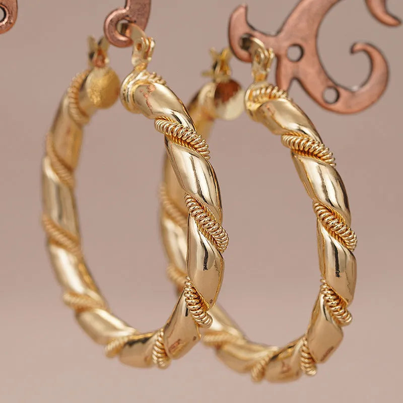 Geometric copper ear clips for women in a golden colour with clean line detailing on a white background.