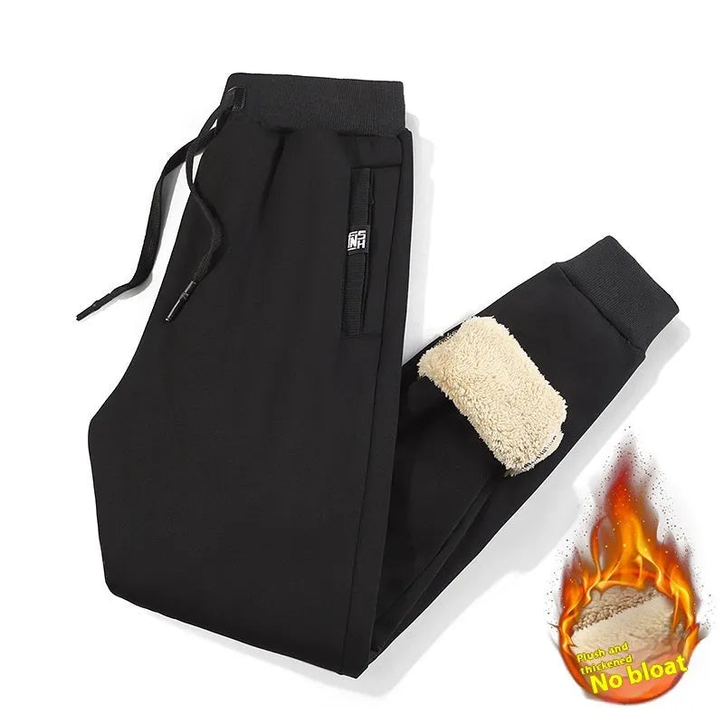Men's grey fleece-lined oversized cotton track pants with a straight leg on a hanger.
