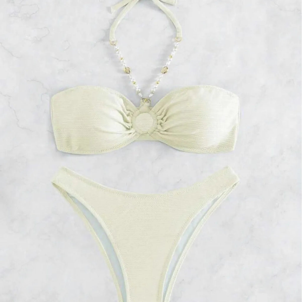 Women's solid colour halterneck bikini set on a mannequin, showing front view in one of four colour options.