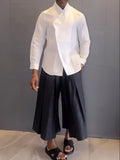 White asymmetric-front long-sleeve shirt and black pleated trousers women's casual set