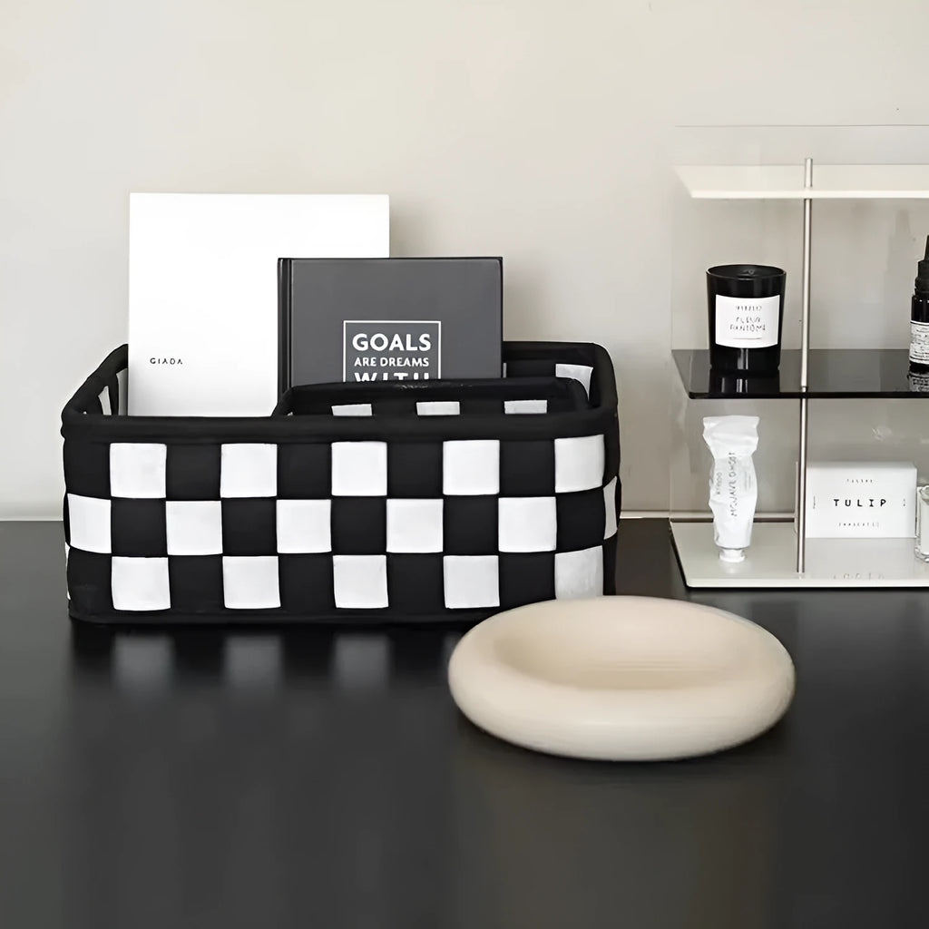 Checkerboard patterned woven felt storage basket folded flat next to it assembled