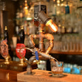 Iron pipe industrial retro robot design table lamp in retro colour on a wooden desk
