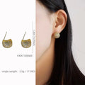 Gold and white women's drop earrings with geometric sphere and diamond-cut golden bean design