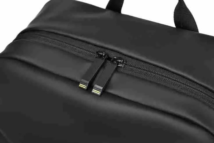 Large waterproof backpack in PU leather with sewing thread detailing, includes computer bag
