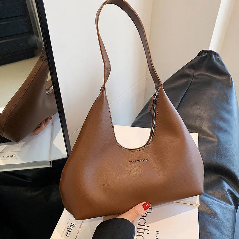 Brown retro-style PU leather pillow-shaped shoulder handbag with a single strap.