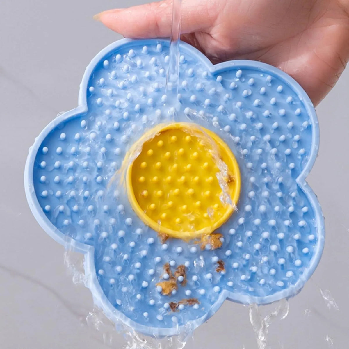 Flower-shaped silicone lick mat for dogs and cats with suction cups on the back, in assorted colours.